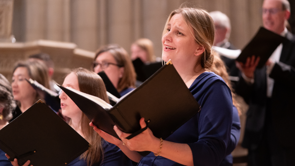 A female singer with Cathedral Choral Society performs with heartfelt feeling.